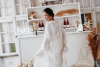 32 a jaw-dropping maxi fringe cover up with long sleeves is a lovely idea for a boho bride, it’s a fantastic solution to try