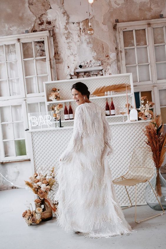 a jaw-dropping maxi fringe cover up with long sleeves is a lovely idea for a boho bride, it's a fantastic solution to try