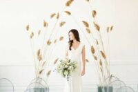 32 a minimalist wedding ceremony space with clear chairs and soem dried herbs for creating an altar