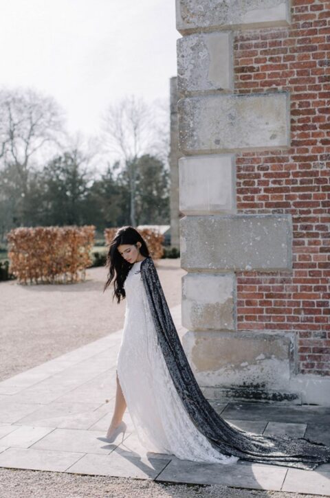 a long black sequin bridal cape creates a contrast and brigns chic to the bridal look