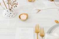 34 a minimalist neutral wedding table setting with white linens, grey plates and chargers, candles, gold cutlery and dried blooms