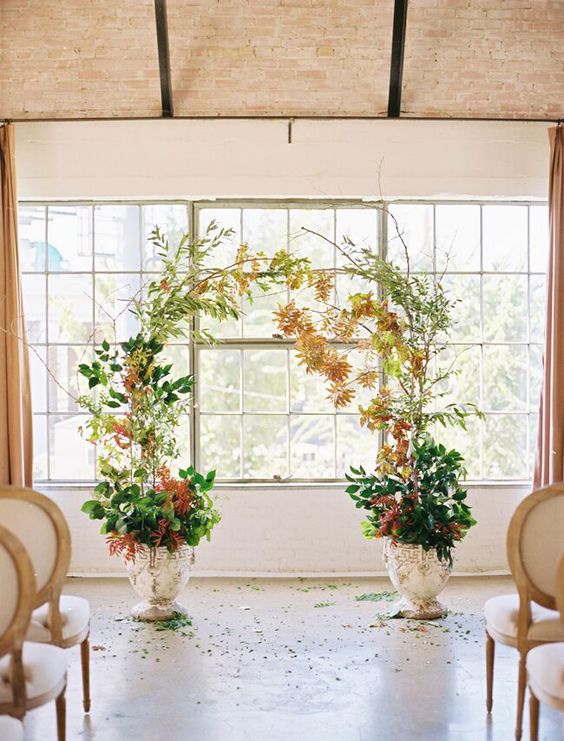 a simple and catchy fall wedding altar of greenery and bright fall leaf branches in pots is a stylish idea