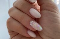 37 milky nails with a single accent nail done with holographics are amazing for a bride who wants a fresh touch for her manicure