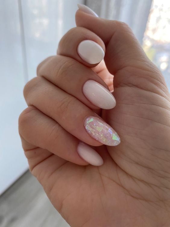 milky nails with a single accent nail done with holographics are amazing for a bride who wants a fresh touch for her manicure