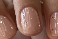 40 nude wedding nails accented with large sparkles are a great take on classic nude manicures, with a glam twist