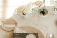 42 a neutral winter wedding place setting with white and blush roses and baby’s breath, neutral plates and simple modern cutlery