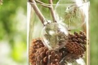 47 a natural winter centerpiece with pinecones and transparent ornaments with fir branches is ideal for winter wedding with a woodland or rustic feel