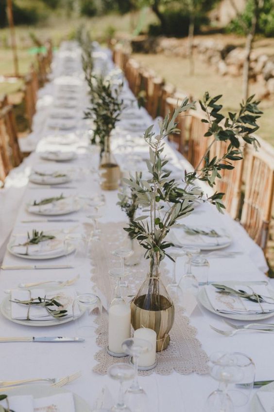 delicate wedding centerpieces of color block gold vases and greenery branches are perfect for an Italian wedding