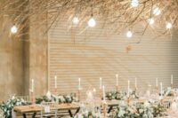 64 such overhead installations of branches and twigs will add interest to the space and will contrast the romantic floral centerpieces on the tables