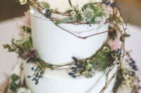 67 a plain white wedding cake decorated with vine, greenery, berries and pink blooms is ideal for a woodland wedding