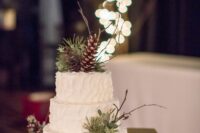 70 a white textural wedding cake decorated with pinecones, twigs, greenery is a cool idea for a winter wedding