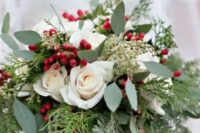 a beautiful Christmas wedding bouquet of greenery, fern, fir, white roses and berries is a timeless idea