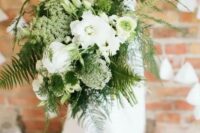 a beautiful wedding bouquet of white blooms and various kinds of greenery and ferns is great for a spring or summer bride