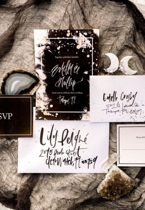 a black and white celestial wedding invitation suite with catchy letters and shiny touches for a modern celestial wedding