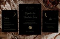 a black celestial wedding invitation suite with gold calligraphy and moon phases is a chic and stylish idea for a wedding
