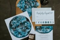a bold blue and rust wedding invitation suite done with watercolor and moon phases