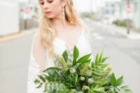 a catchy wedding bouquet of fern, yellow blooms and seed pods is a unique solution for a bride who wants to stand out