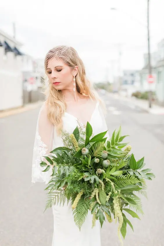 a catchy wedding bouquet of fern, yellow blooms and seed pods is a unique solution for a bride who wants to stand out