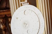 a cool celestial wedding sign with a sun, a moon, some stars and constellations is a lovely decor idea for a wedding