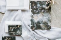 a dreamy celestial wedding invitation suite with a white envelope. black, grey and white cards and gold and white calligraphy is wow