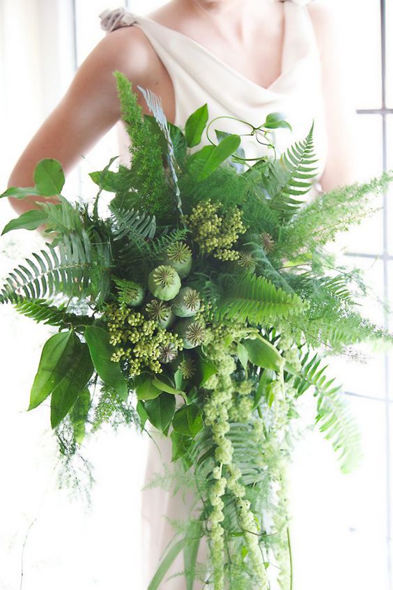 a fantastic cascading wedding bouquet of fern, seeded eucalyptus, seed pods and foliage is a stylish idea for a woodland bride