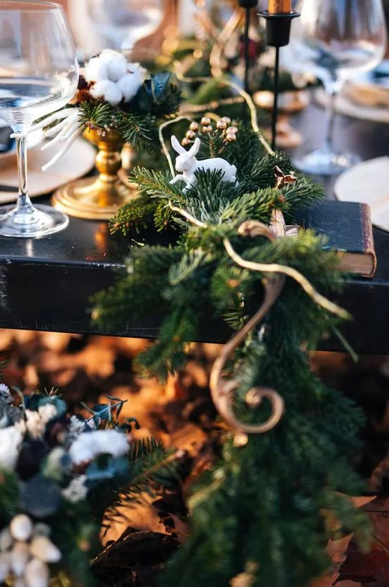 a fir table runner with copper touches and bunny figurines for a winter fairy-tale wedding