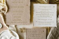 a gorgeous celestial wedding invitation suite with gold foil emboss on handmade paper with moon and stars