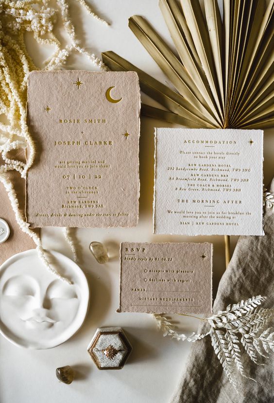 a gorgeous celestial wedding invitation suite with gold foil emboss on handmade paper with moon and stars