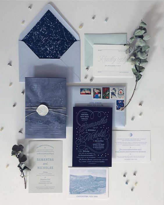 a light blue, navy and mint green plus white wedding invitation suite with calligraphy and constellations is great for a celestial wedding