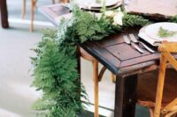 a lush fern table runner with some white blooms is a great idea for a woodland or rustic wedding