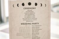 a neutral celestial wedding program with moon phases and black letters is a stylish idea for a celestial wedding