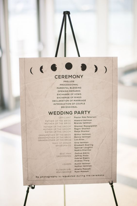a neutral celestial wedding program with moon phases and black letters is a stylish idea for a celestial wedding
