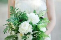 a pretty and classic wedding bouquet of greenery, fern and white blooms will easily fit a woodland wedding, too