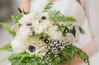 a pretty wedding bouquet of fern, white anemones, ranunculus and baby’s breath plus yellow silk ribbons