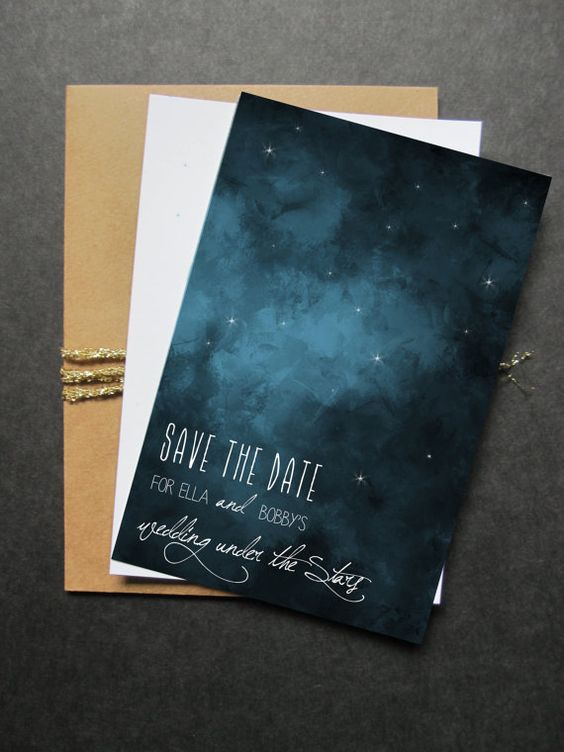 a simple and stylish wedding save the date with stars printed, packed into a kraft paper envelope with gold yarn