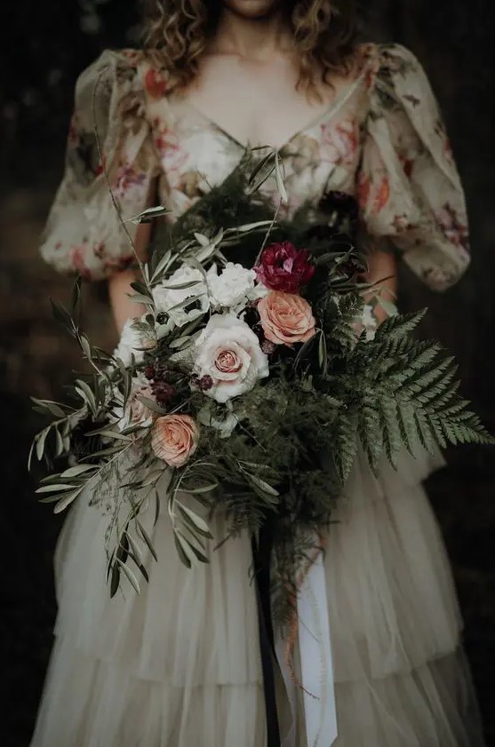 a textural and dimensional wedding bouquet of white, pink and peachy blooms, greenery and berries for a woodland bride