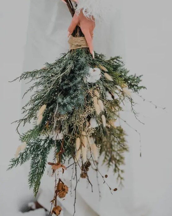 a woodland winter wedding bouquet of evergreens, berries, cotton, twigs and bunny tails is a fantastic idea
