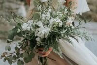 an airy and textural wedding bouquet of eucalyptus, fern, greeneyr and white blooms is a lovely idea for any bride