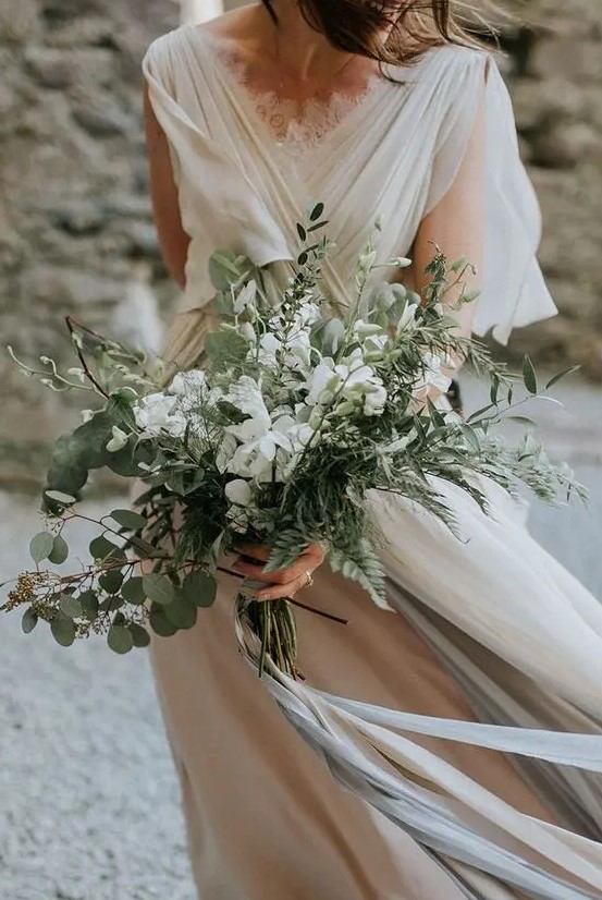 an airy and textural wedding bouquet of eucalyptus, fern, greeneyr and white blooms is a lovely idea for any bride