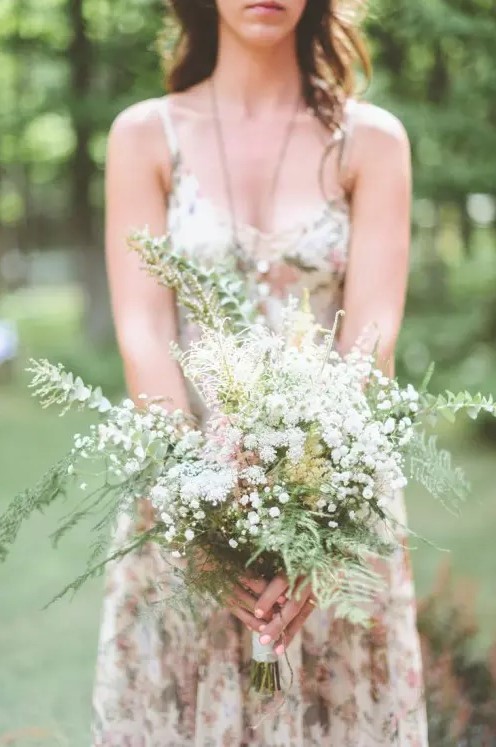 an airy spring woodland wedding bouquet of eucalyptus, ferns, baby's breath and herbs is a lovely idea