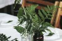 some ferns in vintage apothecary bottles are great for a woodland wedding, add figs for more interest