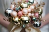 02 a beautiful winter wedding bouquet made of pastel and metallic ornaments of various sizes and of gilded leaves is a lovely idea for a winter bride