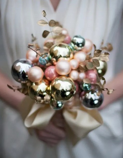 a beautiful winter wedding bouquet made of pastel and metallic ornaments of various sizes and of gilded leaves is a lovely idea for a winter bride