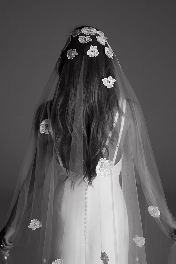 a cathedral veil with white lace floral applique are a gorgeous combo for a refined and chic wedding