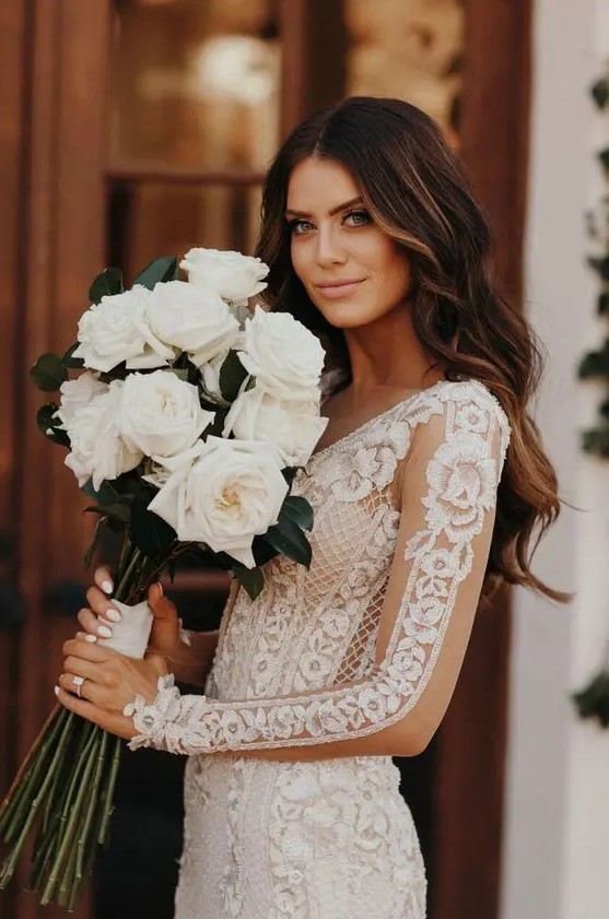 a lovely and chic white rose wedding bouquet with neutral ribbons is a chic and refined idea for any bride, such a combo always works