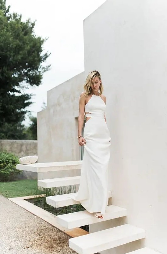 a halter neckline wedding dress with side cutouts and a strappy back for a modern tropical bride