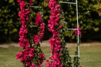07 a beautiful magenta wedding arch with a bit of greenery is a bold and lovely decor idea for a modenr colorful wedding