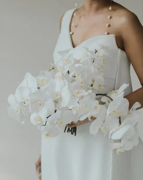 a classic and sophisticated cascading white orchid wedding bouquet is a lovely idea for a refined modern bride or for a tropical one
