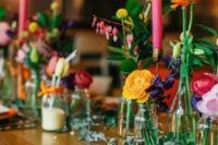 07 a wedding tablescape accented with super colorful flowers, pink candles and orange napkins looks vibrant