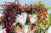 08 a bold lush floral wedding arch from light pink to mauve, burgundy, peachy pink, orange and yellow florals is a statement idea